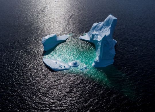 (FILES) This aerial file photo taken on June 29, 2019 shows an iceberg floating in Bonavista Bayin Newfoundland, Canada. - Two days after a climate summit failed to deliver game-changing pledges to slash carbon emissions, the United Nations warned on September 25, 2019 that global warming is devastating oceans and Earth's frozen spaces in ways that directly threaten a large slice of humanity. (Photo by Johannes EISELE / AFP)